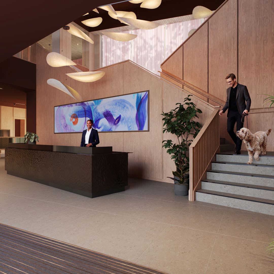 Two members of the concierge team behind the reception desk at Ferry Island