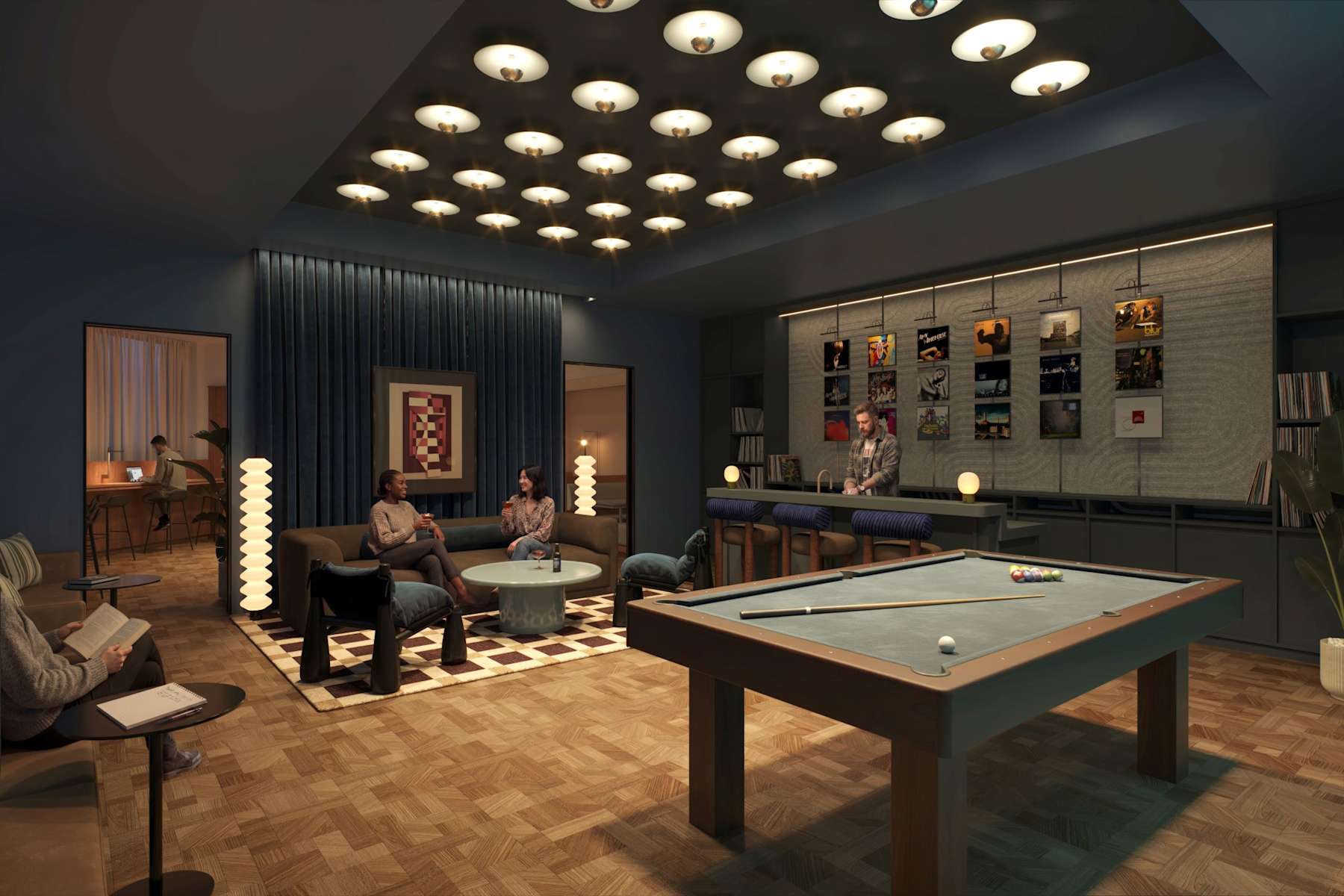 Two residents beside the pool table in Adele's music and games room