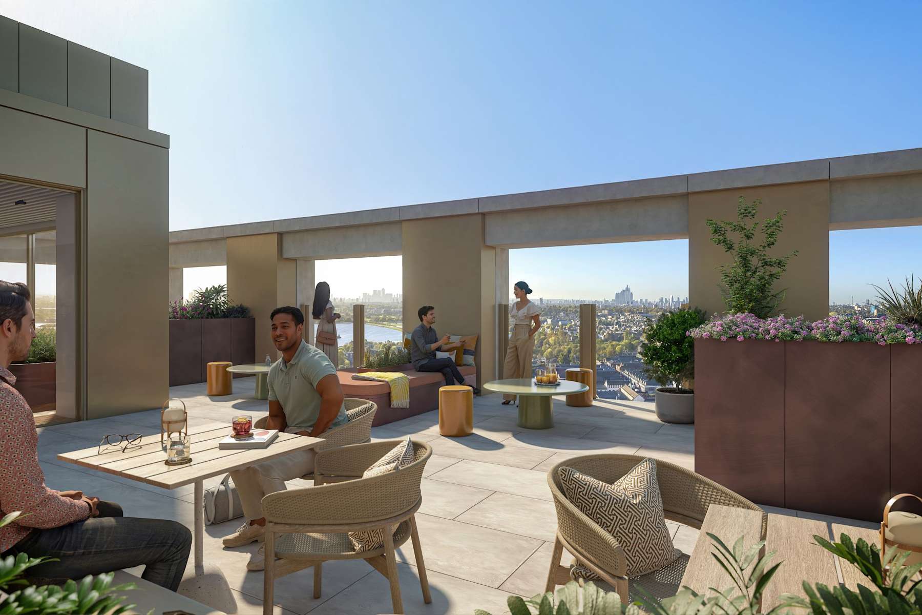 Two residents raising glasses on a rooftop terrace at sunset
